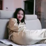 Petite Japanese Girl with Bangs Strips to Nude in Cozy Bedroom Wearing Gold Tracksuit 10 asian woman gold tracksuit