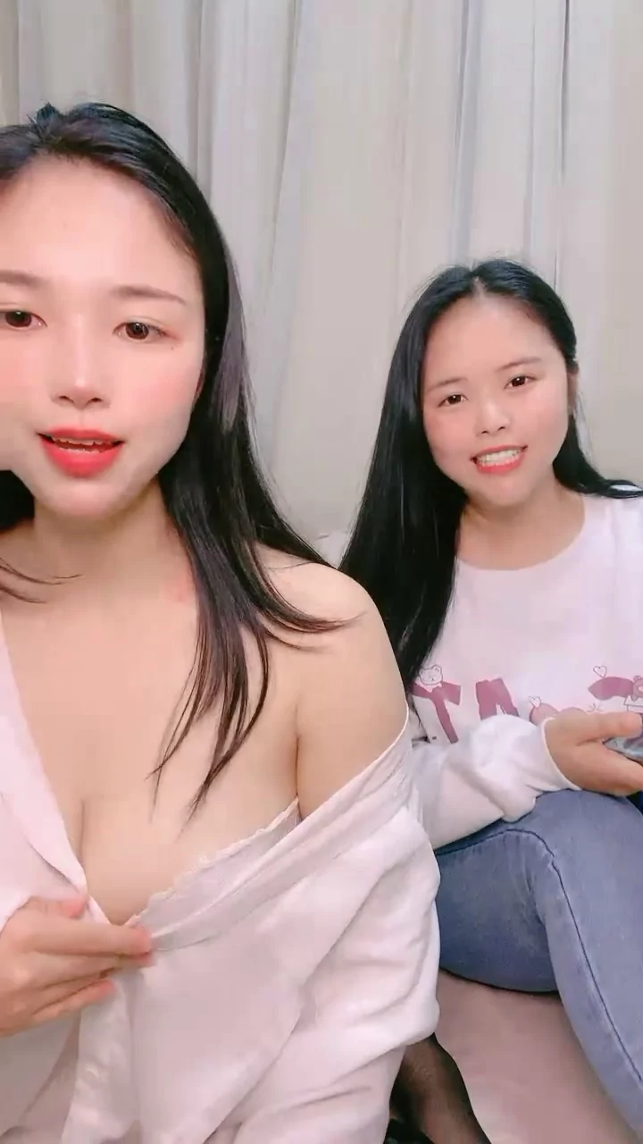 Play video: Twin-Like Japanese Lesbians Scissor with Strapon — Bedroom POV Action
